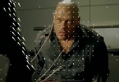 Still from the movie The Matrix showing Morpheus sitting on a chair, with white arrows showing the movement of pixels in P and B frames