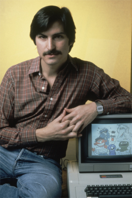 Portrait of a young Steve Jobs with an early Apple Computer.