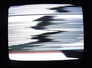 Black and white glitch imagery from a CRT TV.
